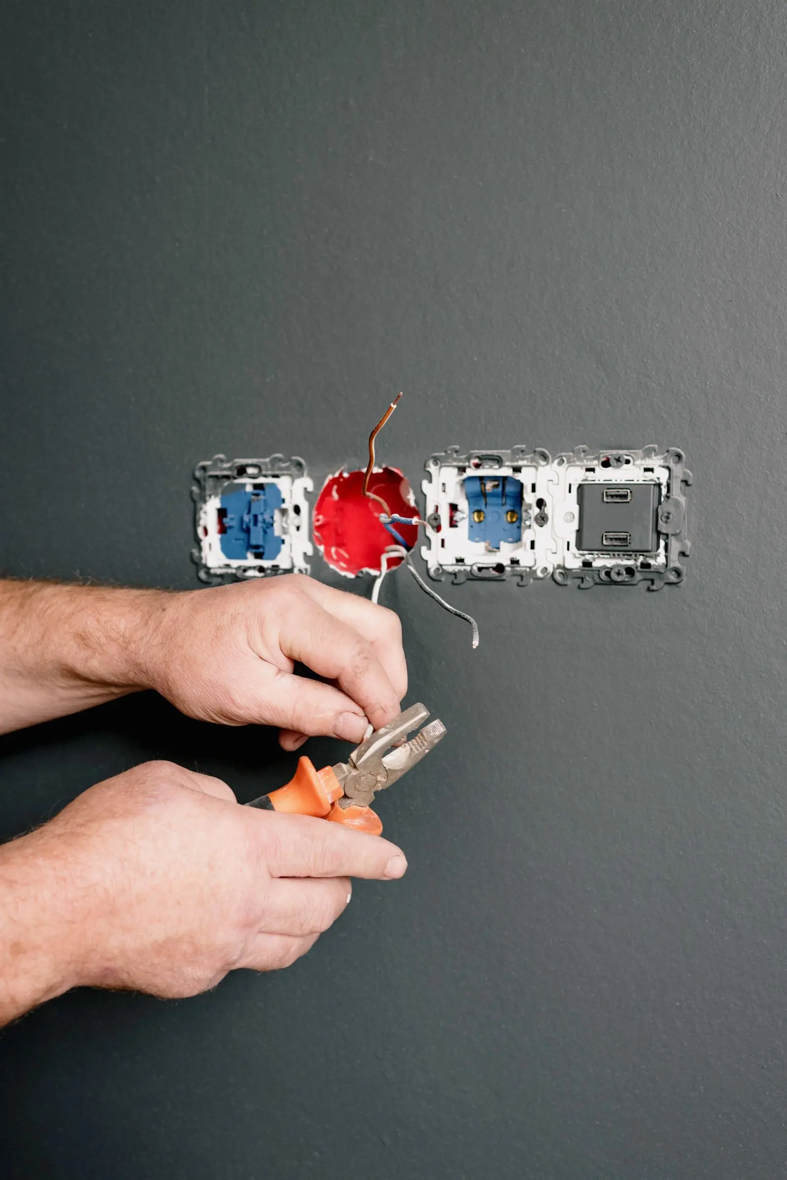 An electrician wiring power points in a home.
